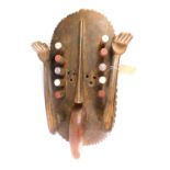 An African tribal Grebo Kru surrender mask, with two raised hands, shaped tongue, Liberia circa 1950