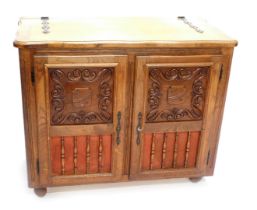 A oak cased jukebox, the hinged lid inset to the interior with a Flemish style machine woven tapestr