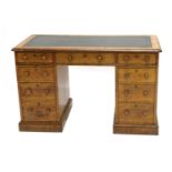 A late Victorian oak pedestal desk, the rectangular top inset with green leather and a moulded edge