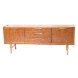 A 1970s/80s teak sideboard, with three drawers flanked by two doors, 72cm high, 162cm wide.