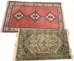 A Turkish rug, decorated with lozhenges on a pink ground, and a similar beige and blue Turkish rug,