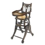 A late 19thC beech child's metamorphic high chair, with a pierced laminate seat, shaped legs and spo