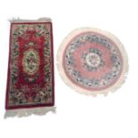 A Chinese red ground cut wool rug, with floral decoration and a circular pink ground Chinese rug, 18
