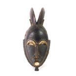 An African tribal Baule Divination mask, with two horns, Cote D'Ivoire circa 1930, 33cm high.
