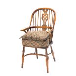 An ash and elm Windsor chair, the pierced splat, shaped arms and solid seat, on turned legs with cri