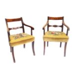 A pair of Regency mahogany open armchairs, each with a bar back, moulded arms, on bobbin turned supp