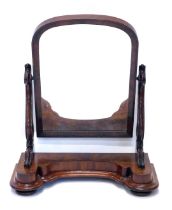 A Victorian figured mahogany dressing table mirror, with an arch plate, on shaped pierced supports,