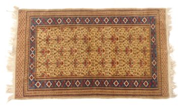 An Afghan rug, with a geometric design of urns etc. on a gold ground, 98cm x 158cm.