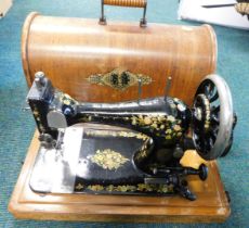 A cased Singer sewing machine.