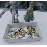 Two Lladro figures, comprising boy carrying boat and girl carrying two pails, and a small group of W