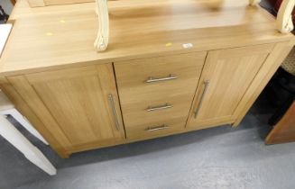 A beech sideboard, with arrangement of two cupboard doors and three drawers.