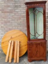 A circular pine kitchen table and a corner cabinet. (2)