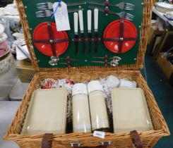 A wicker picnic hamper, and plastic Tupperware.