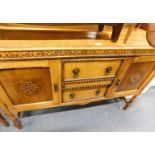 A stained oak mirror back sideboard, the arched back above arrangement of two drawers and two cupboa