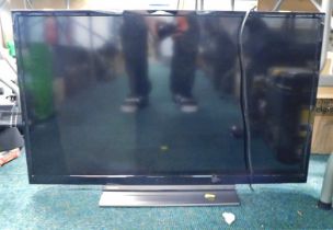 A Toshiba 32" flat screen television, model 32LL3CS830B, with two remote controls.
