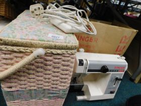 A Singer electric sewing machine and sewing basket. WARNING! This lot contains untested or