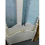 A cream painted pine single bed frame.