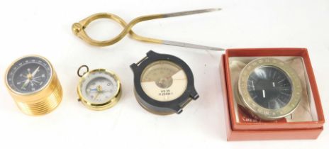 A group of reproduction compasses, comprising a plated and brass compass, plastic cased AK39 compass