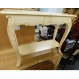 A cream painted console table.