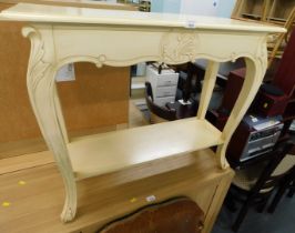 A cream painted console table.