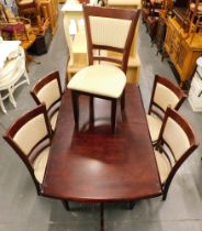 A mahogany extending kitchen table and five matching chairs.