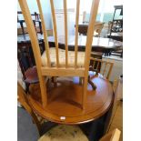 A walnut extending circular dining table, five chairs, three tier whatnot, and a hardwood coffee tab