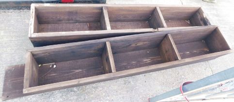 Two wooden three sectional feeding troughs.