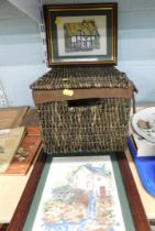 A brown wicker storage basket, and two tapestry pictures. (3)