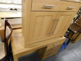 Two items of oak office furniture, comprising a sideboard and a three drawer desk.