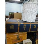 A canvas and wooden bound travel trunk, floral painted tin trunk, and two wicker baskets. (4)