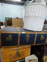 A canvas and wooden bound travel trunk, floral painted tin trunk, and two wicker baskets. (4)