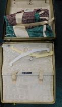 A Revrobe travel case and contents of vintage clothing.