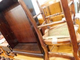 Two cane side chairs and a stag mahogany bookshelf.
