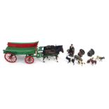 A Britain's diecast model cart, in green with two pull horses, small group of farm animals and figur