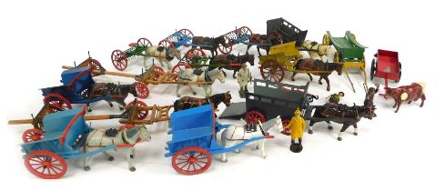 A group of Britain's lead horse and cart figures, to include carts, ploughs, log pullers, etc. (1 tr