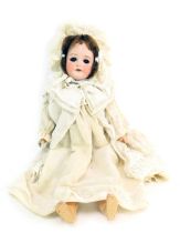 A German porcelain Simon Halbig bisque headed doll, female with blue eyes, teeth and brown hair, on