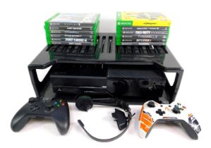 An Xbox one, in black with storage shelf, two controllers and various games to include Cyberpunk, 20