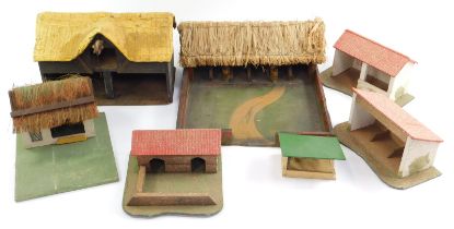 A group of model outbuildings, some with thatched roofs. (1 box)