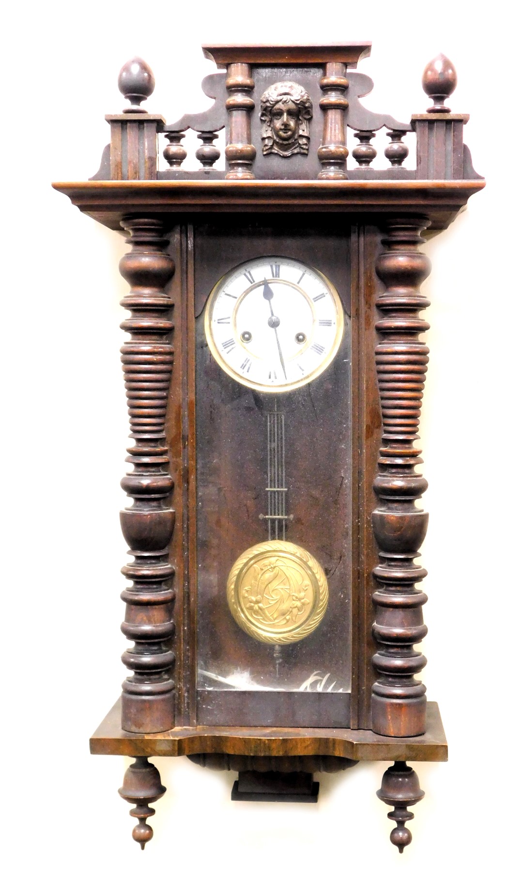 A late 19thC oak cased Vienna wall clock, circular enamel dial with chapter ring bearing Roman nume