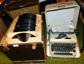 A Deluxe typewriter in case, and a box of long playing vintage records.