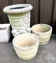 Two circular garden planters, a figural garden planter with foliate decoration.