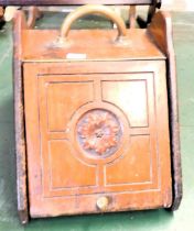 A late 19th/early 20thC mahogany coal scuttle, with brass ring handle, the hinged door carved with f