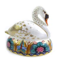 A Royal Crown Derby porcelain paperweight modelled as a swan, silver stopper and red printed marks,