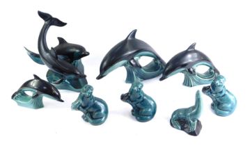 A group of Poole pottery, comprising four dolphins and three seals. (1 tray)