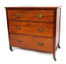 An Edwardian mahogany chest, of three drawers, with bracket swing handles, on stiles terminating