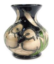 A Moorcroft pottery vase decorated in the Siblings pattern, impressed marks to underside bearing sig