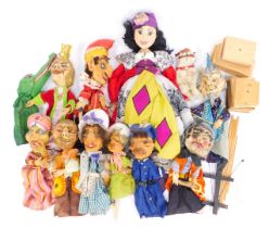 A collection of mid century theatrical puppets, each with a papier mache face, embroidered fabric cl