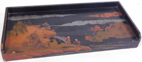 An Oriental black lacquer serving tray, with a moulded border, and painted Oriental scene with bridg