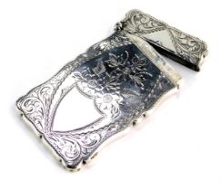 An Edward VII silver card case, with engine turned floral scroll decoration depicting baskets of flo