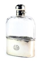 A silver cased and cut glass hip flask, the bottom rim inscribed AJEM, retailed by A Barrett and Son